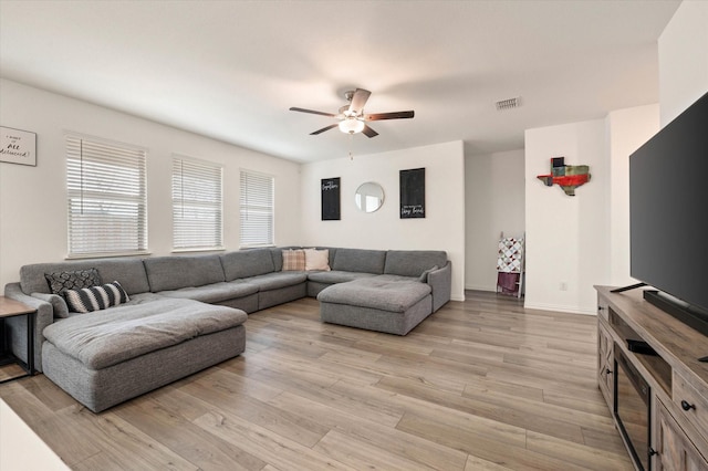 living room with ceiling fan and light wood-type flooring