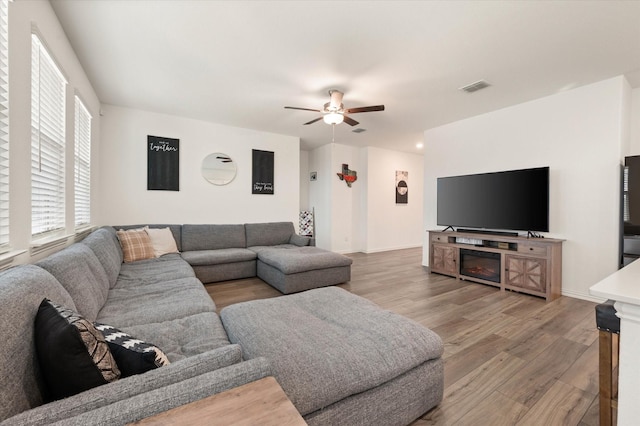 living room with hardwood / wood-style flooring and ceiling fan