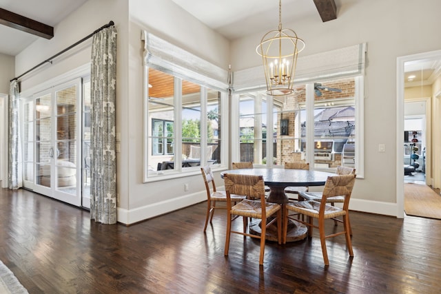 dining area featuring a chandelier, beamed ceiling, baseboards, and wood finished floors