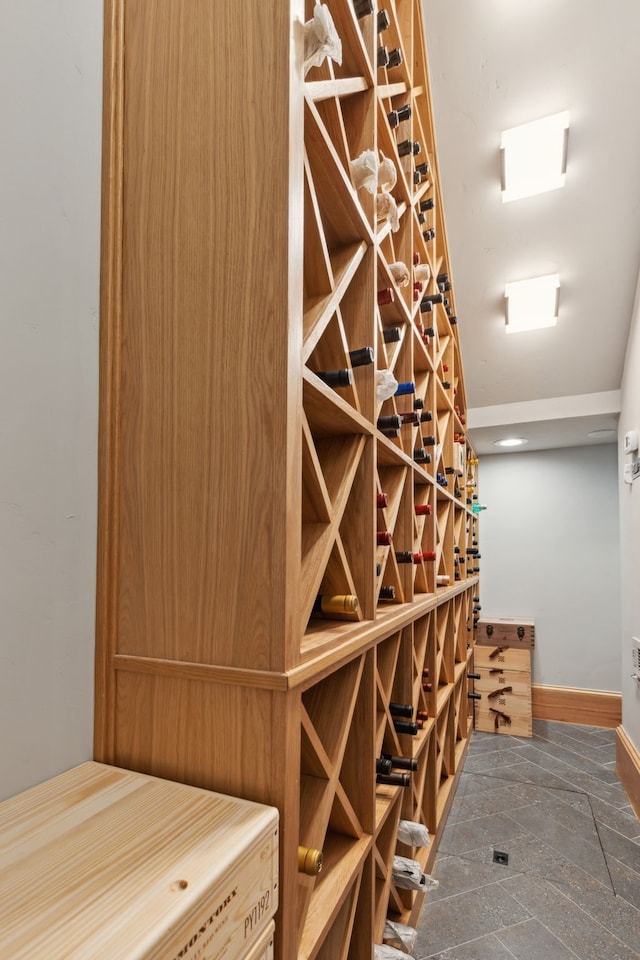 wine area with stone finish flooring and baseboards