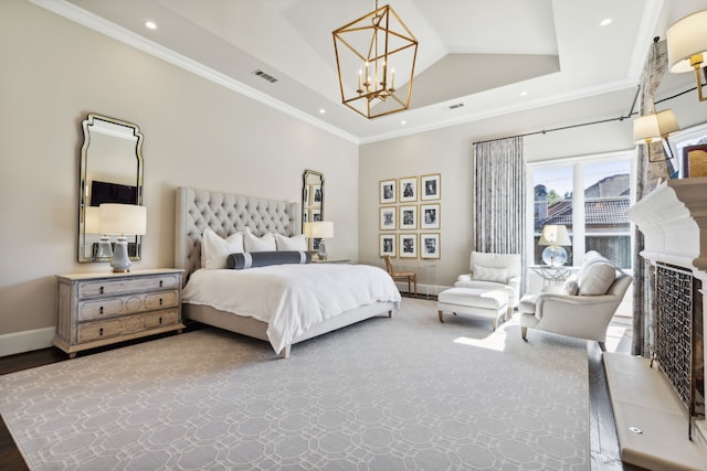 bedroom with ornamental molding, a tray ceiling, and visible vents