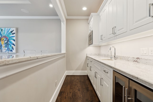 bar with baseboards, wine cooler, ornamental molding, dark wood-style flooring, and a sink