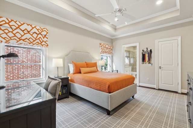 bedroom with a raised ceiling, crown molding, and baseboards