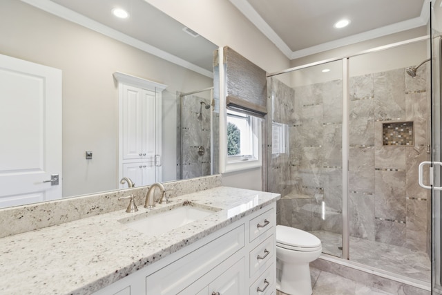 full bath featuring crown molding, a shower stall, toilet, and vanity