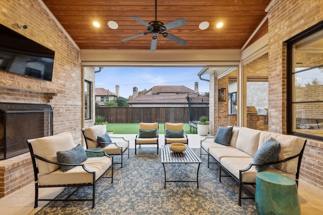 view of patio featuring a ceiling fan, outdoor lounge area, and fence