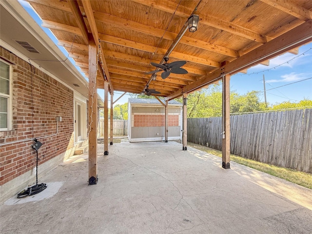 view of patio / terrace with ceiling fan and an outdoor structure