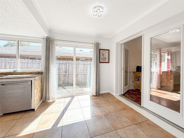 doorway to outside featuring light tile patterned flooring, crown molding, and a textured ceiling