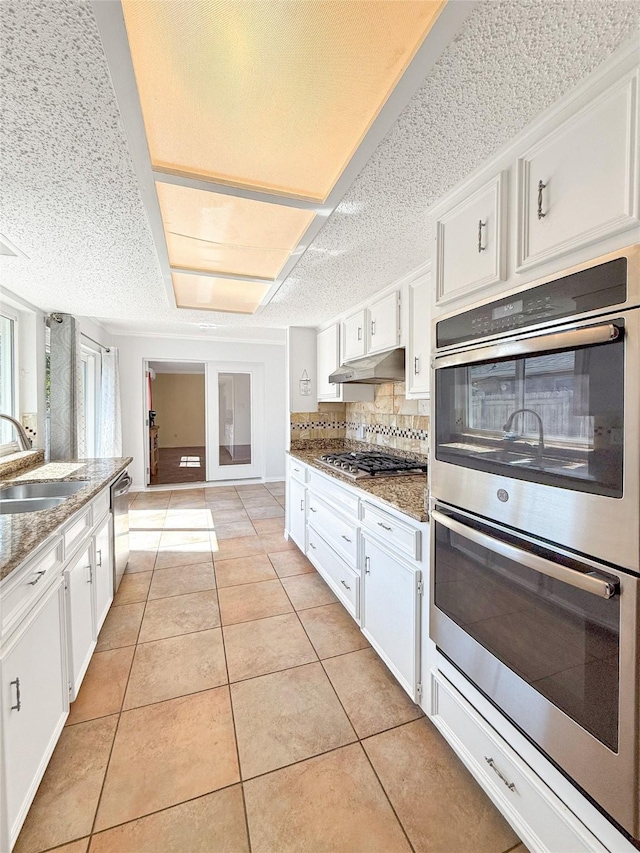 kitchen with white cabinetry, sink, and stainless steel appliances