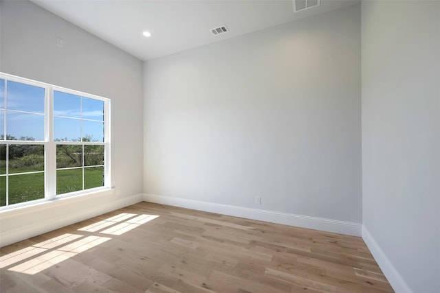 unfurnished room with light wood-type flooring