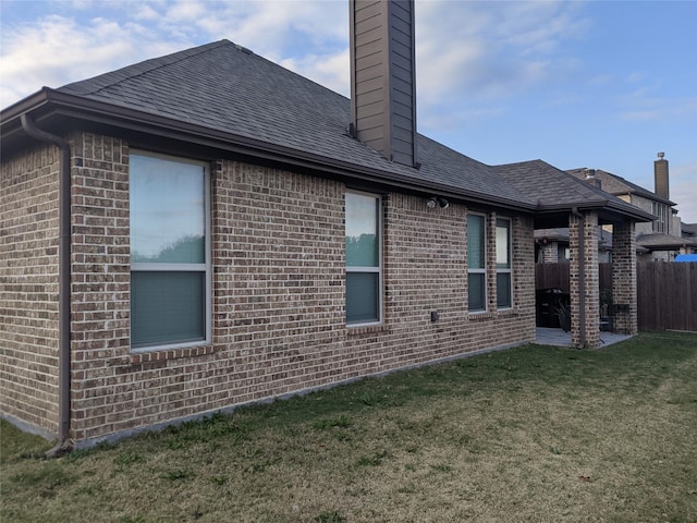 view of side of property featuring a yard