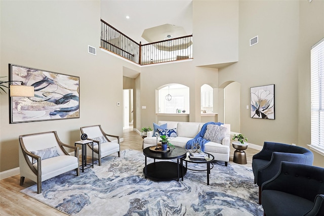 living room with a high ceiling and hardwood / wood-style floors