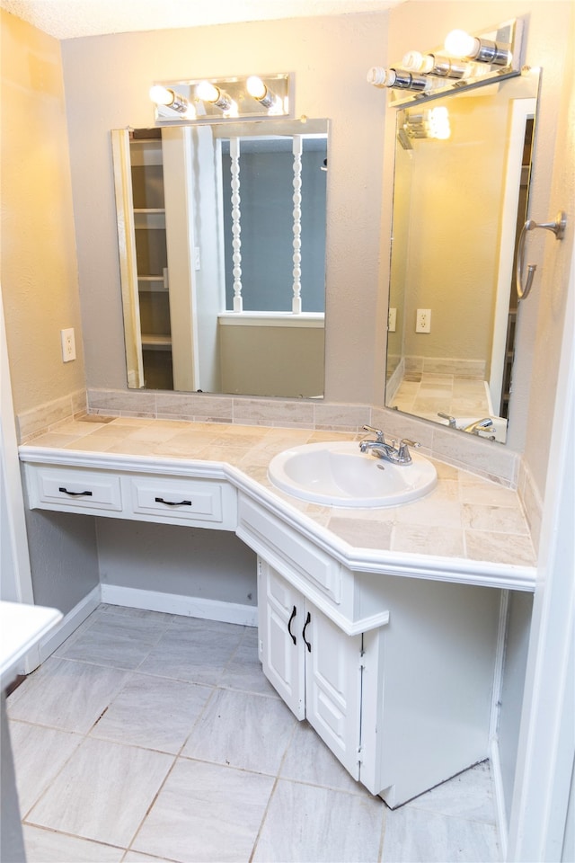 bathroom with tile patterned flooring and vanity