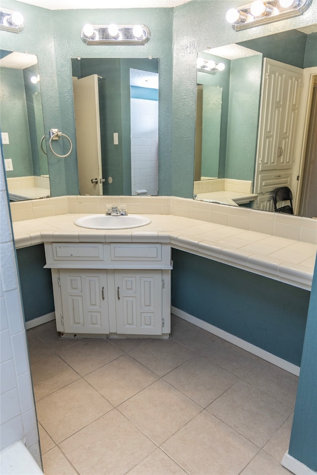 bathroom with tile patterned floors and vanity