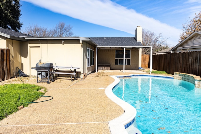 view of pool featuring a patio and a grill