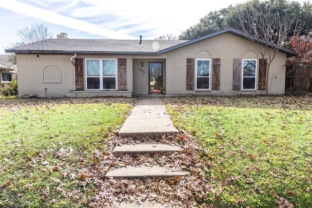 ranch-style home with a front lawn