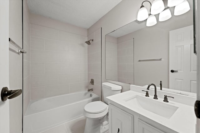 full bathroom featuring tile patterned floors, vanity, a textured ceiling, tiled shower / bath combo, and toilet