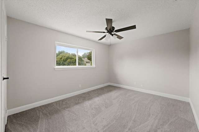 carpeted empty room with a textured ceiling