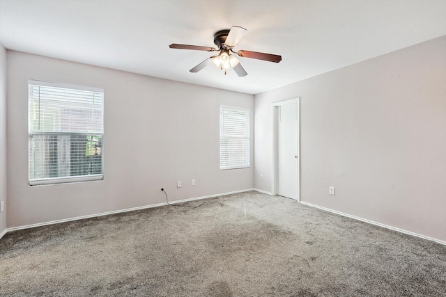 carpeted empty room featuring ceiling fan