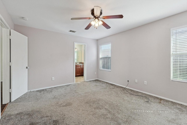 spare room featuring light carpet and ceiling fan