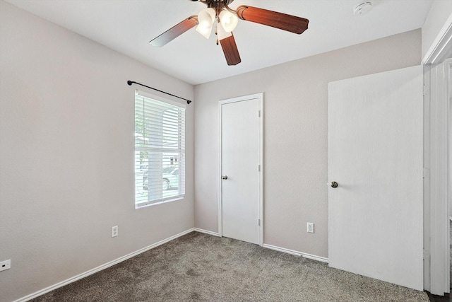 unfurnished bedroom with carpet floors and ceiling fan