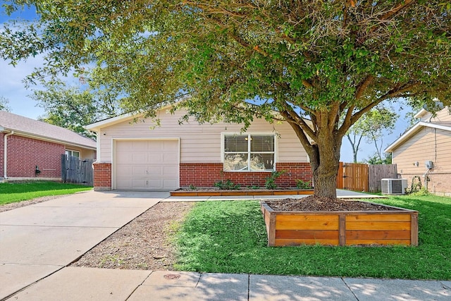 ranch-style house featuring a front yard, a garage, and central air condition unit