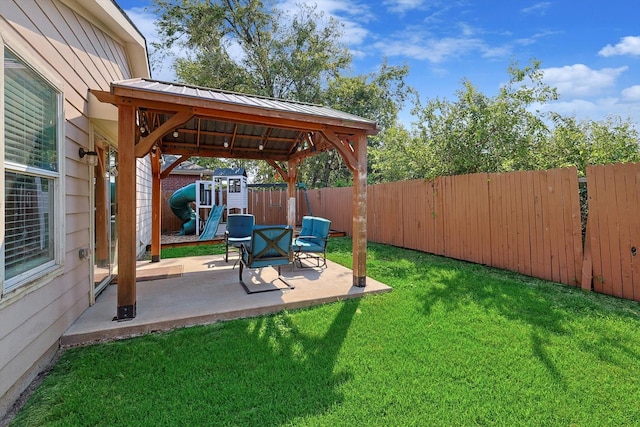 view of yard with a gazebo, a playground, and a patio area