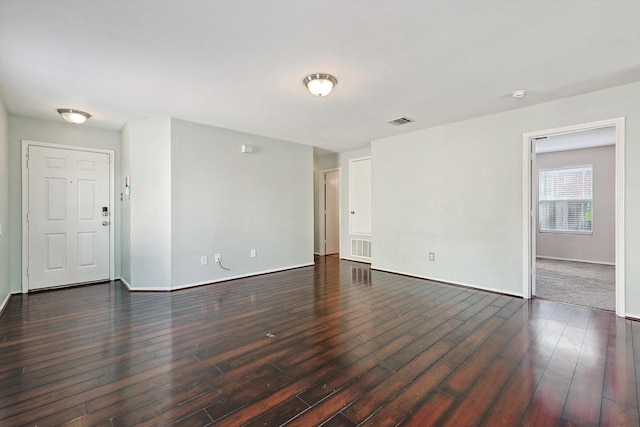 unfurnished room with dark wood-type flooring