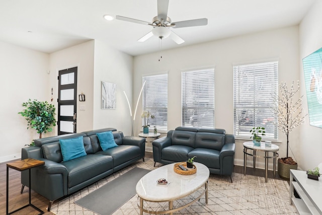 living room with light hardwood / wood-style floors and ceiling fan