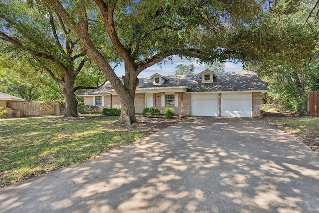 view of front of home featuring a garage and a front lawn