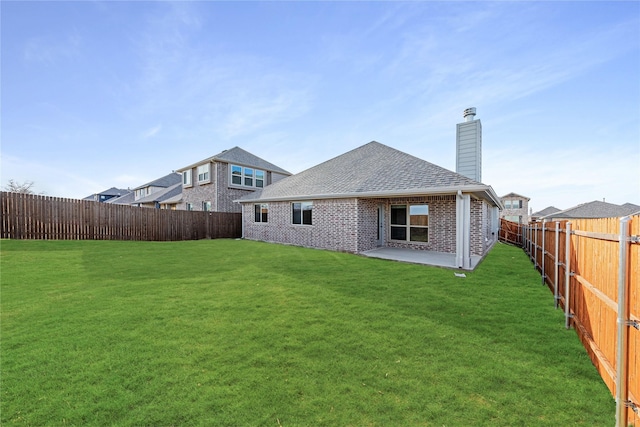 rear view of property with a patio and a yard