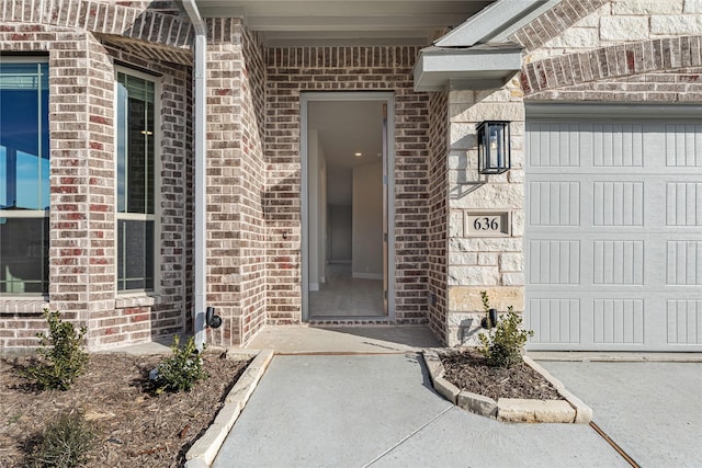 view of exterior entry with a garage