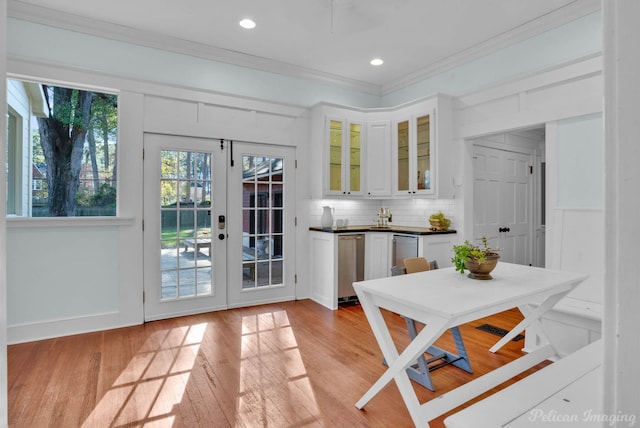 doorway to outside with french doors, light wood-type flooring, recessed lighting, and crown molding