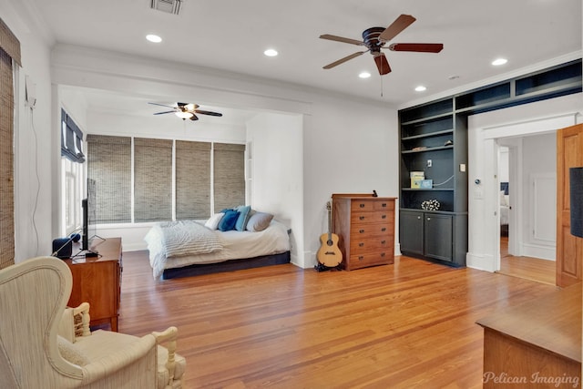 bedroom featuring hardwood / wood-style floors, ceiling fan, and ornamental molding