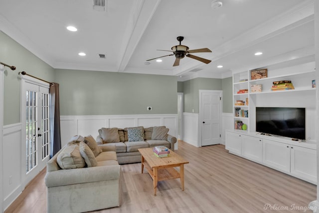 living room featuring crown molding, ceiling fan, light wood-type flooring, built in features, and beam ceiling