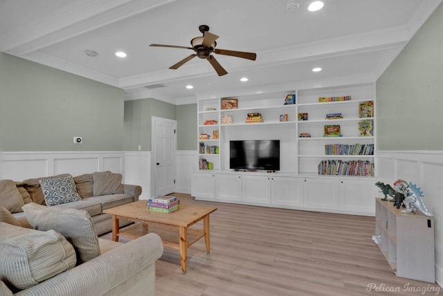 living room with ornamental molding, built in shelves, ceiling fan, light hardwood / wood-style flooring, and beamed ceiling