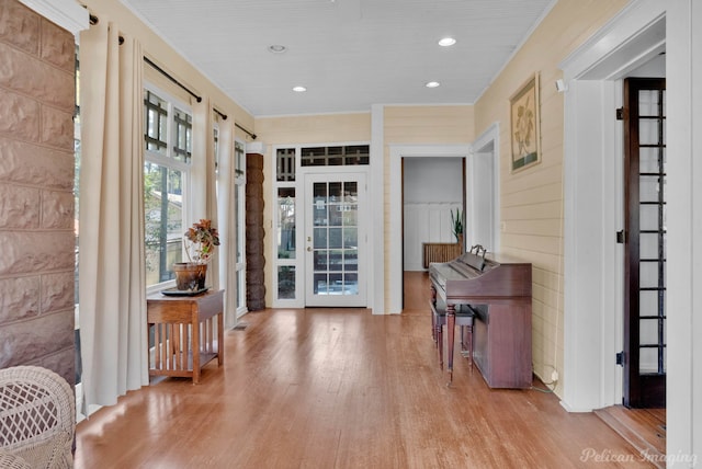 foyer featuring light hardwood / wood-style flooring and wood walls