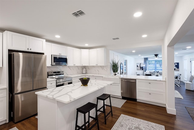 kitchen with sink, white cabinets, and appliances with stainless steel finishes