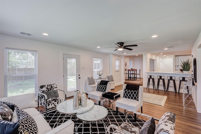 living room featuring hardwood / wood-style flooring and ceiling fan