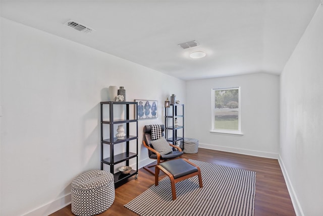 living area featuring dark hardwood / wood-style flooring and vaulted ceiling