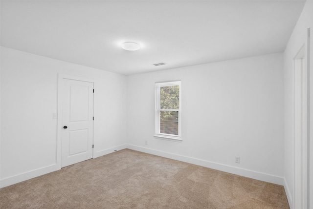 spare room with light carpet