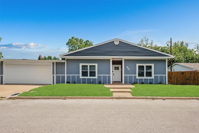 ranch-style home featuring a garage and a front lawn