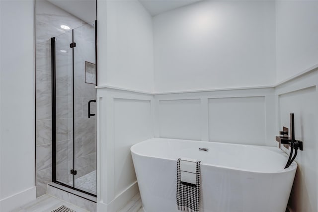 bathroom with separate shower and tub