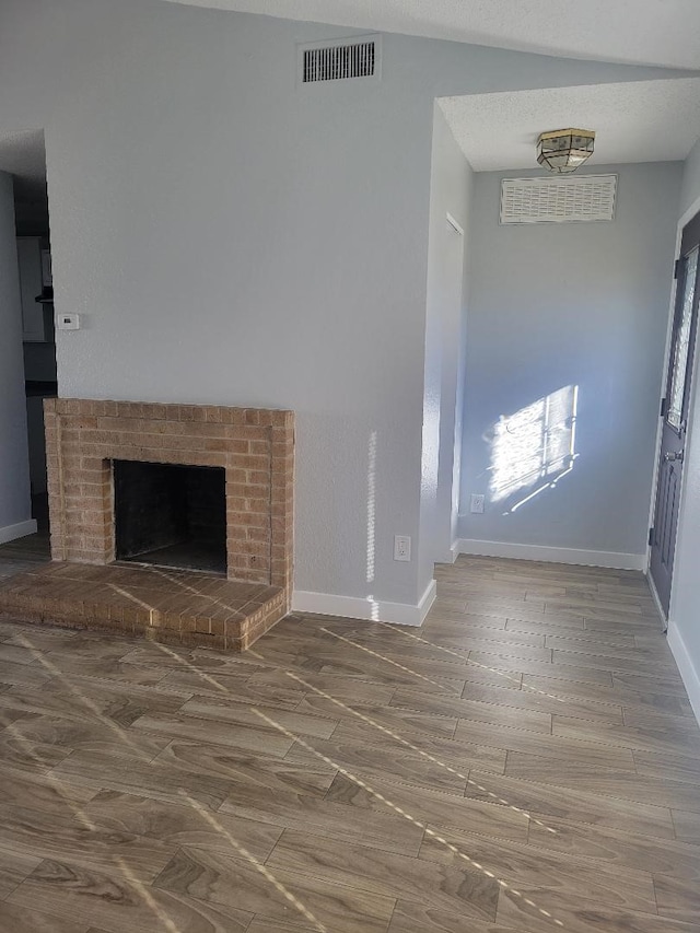 unfurnished living room with hardwood / wood-style floors and a fireplace