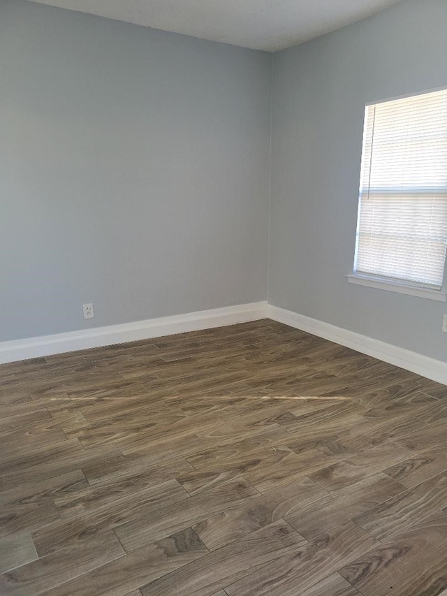 unfurnished room featuring dark wood-type flooring