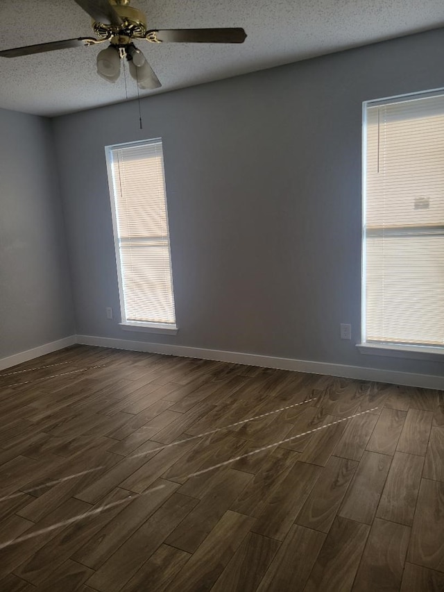 unfurnished room featuring a textured ceiling, ceiling fan, and dark wood-type flooring