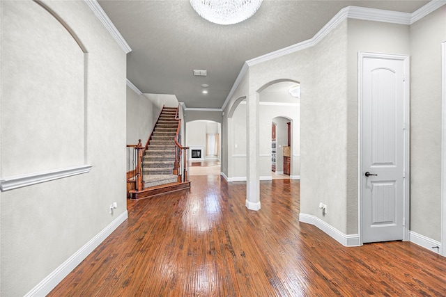 foyer featuring hardwood / wood-style flooring and crown molding