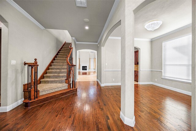 entrance foyer featuring dark hardwood / wood-style floors and ornamental molding