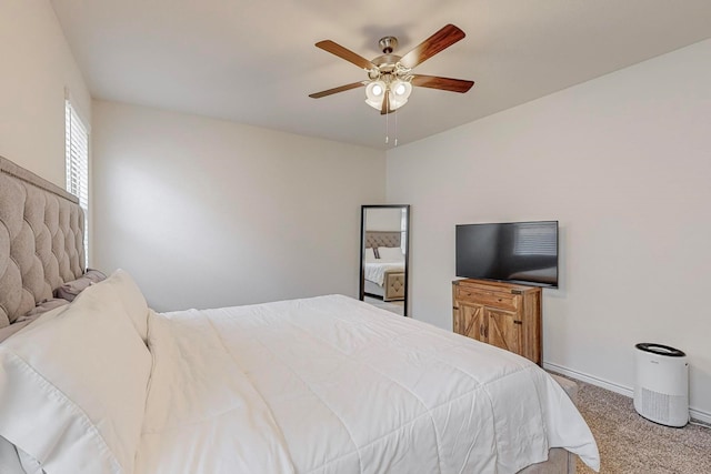 bedroom with ceiling fan and light colored carpet