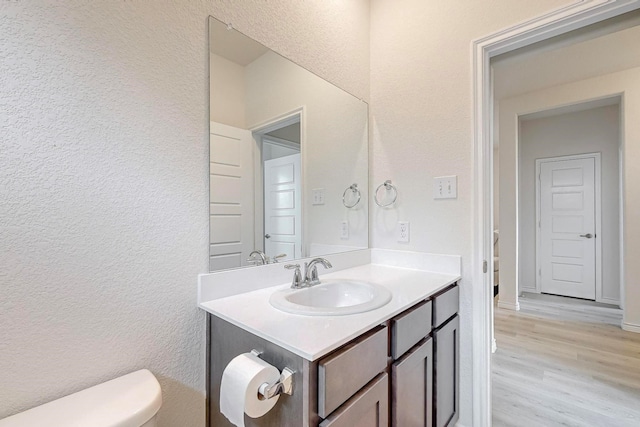 bathroom featuring hardwood / wood-style floors, toilet, and vanity