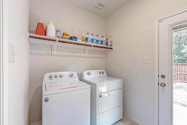 washroom with washing machine and clothes dryer